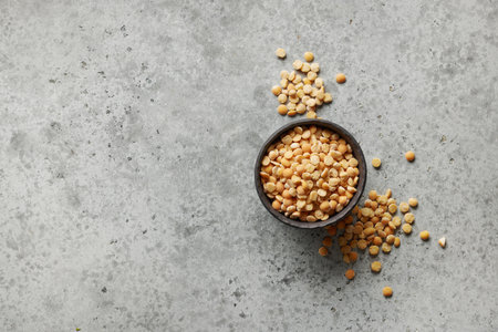 bowl of dried peas on grey kitchen table background, top viewの写真素材