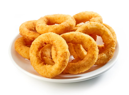 plate of fried onion rings isolated on white backgroundの写真素材