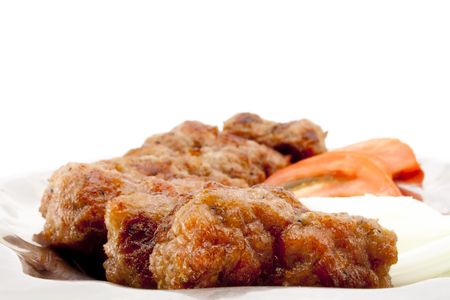 Kebabs with tomatoes and onion on silver dishの写真素材