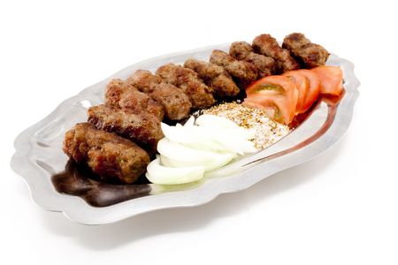 Kebabs with tomatoes and onion on silver dishの写真素材