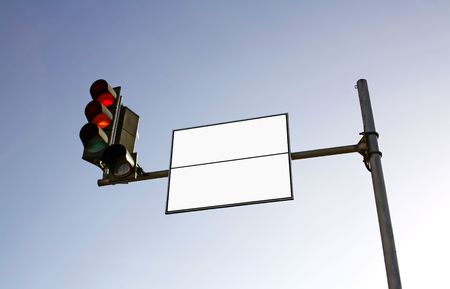 Empty road sign with semaphore against blue skyの写真素材