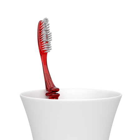 Red plastic toothbrush in a plastic cupの写真素材