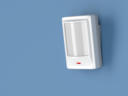 Motion detector attached on blue wallの写真素材