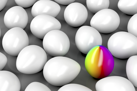 Concept image with one unique colorful egg among other white eggsの写真素材