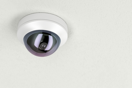 Surveillance camera attached on white ceiling の写真素材