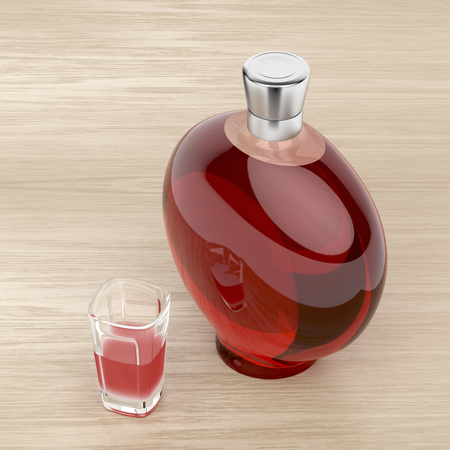 Red liqueur bottle and a glass on wood backgroundの写真素材