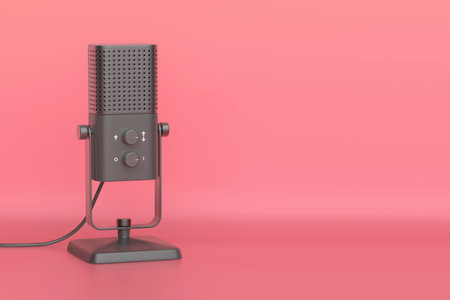 Black studio microphone on pink backgroundの写真素材