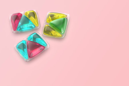 Three different laundry detergent pods on pink backgroundの写真素材