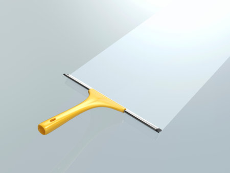 Cleaning the glass with yellow squeegeeの写真素材