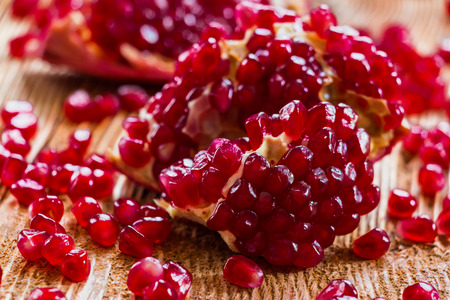 Juicy fresh pomegranates on old wooden table, selective focusの写真素材