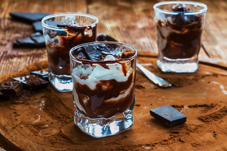 Ice cream with chocolate in small glasses on cocoa background.の写真素材