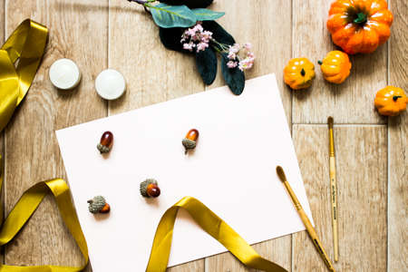 Fall artist flatlay. High quality photo. Pumpkins, flowers and candles. Artist workspace with brush...