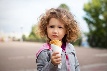 Little girl with icecream in the park.の写真素材