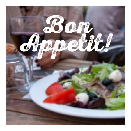 Blurred background with closeup of a young womans hands as she is having dinner.の写真素材
