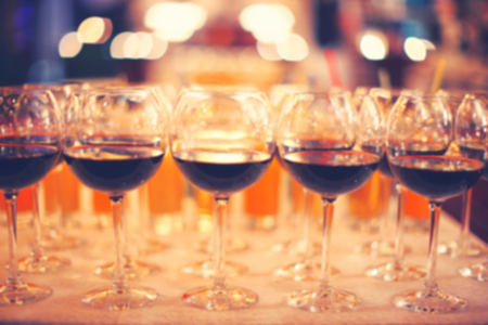 Blurred background with glasses of wine, standing in a row.  の写真素材