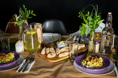 Fresh bread and homemade butter on decorated dinner tableの写真素材