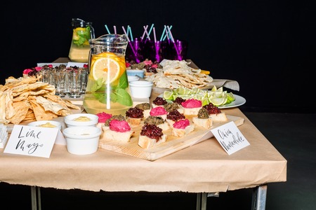 Colorful Traditional Mexican appetizers: various fajitas, nachos,  salsa cruda served on a beautifully decorated table. Guacamole with avocado, lime, tomato, and cilantro with tortilla chipsの写真素材