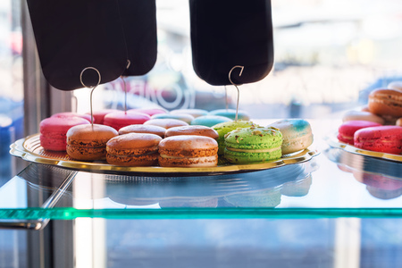 Traditional french colorful macaroons in confectionery shop. Display of delicious pastries in a bakeryの写真素材