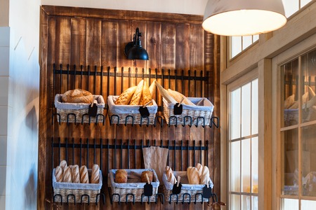 Variety of fresh baked bread in bakery shop. Gourmet breads for saleの写真素材