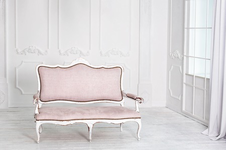 Classical interior with pink sofa. White modern interior with panoramic windows and sofaの写真素材