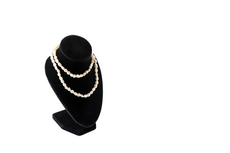 Necklace made of natural pearls on a stand on black background. Luxury women accessoriesの写真素材