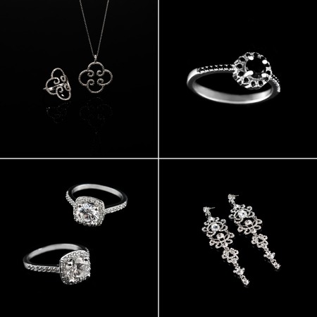 Luxury jewellery set. White gold or silver rings, earrings with crystals and pendant isolated on black. Selective focusの写真素材
