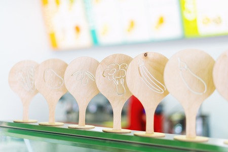 Juice menu in fresh bar. Wooden plates with vegetables and fruitsの写真素材