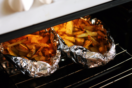 Rusic style potato baked with butter and herbs in foilの写真素材