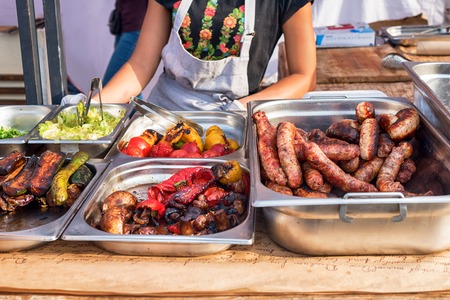 Grilled vegetables and sausages on street food festival