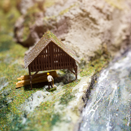 Miniature people: worker on sawmill at the river. Macro photo, shallow DOFの写真素材