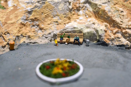 Miniature world: people waiting for their transport on the bus stop. Tourism and public transport themeの写真素材