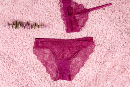 Shopping and fashion concept. Set of glamorous stylish pink sexy lace lingerie, woman accessories on fur backgroundの写真素材