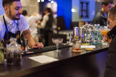 KIEV, UKRAINE - 30 OCTOBER, 2016: Barman festival. Young handsome bartender is making cocktailのeditorial素材