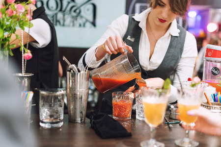 Kyiv, Ukraine - 30 october, 2016: Barman festival. Young pretty woman bartender is making cocktailのeditorial素材