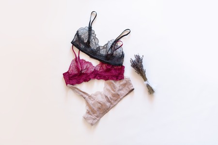 Fashion trendy lace lingerie. Different bra with dried lavender bundle on white background. Beautiful clothing collage to choose from. Colorful womens underwear. Female wardrobe, shopping conceptの写真素材