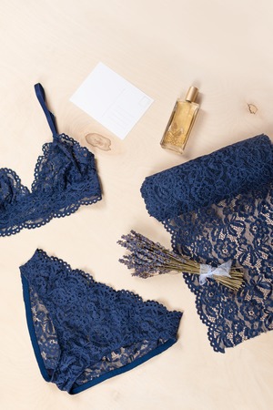 Shopping and fashion concept. Set of glamorous stylish sexy lace lingerie with cosmetic products, woman accessories on wooden background. Top view point, flat layの写真素材