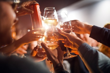 Cheerful friends clinking glasses above dinner table. Alcohol and toasting, party and celebration theme. Congratulations on the event.