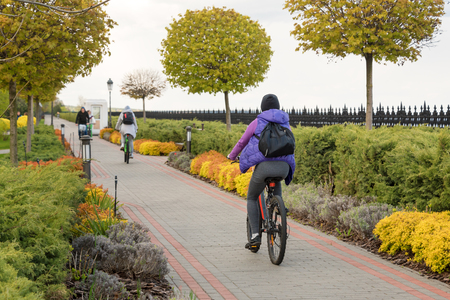 Young people riding bicycles in the park. Fitness, sport, people and healthy lifestyle conceptの写真素材