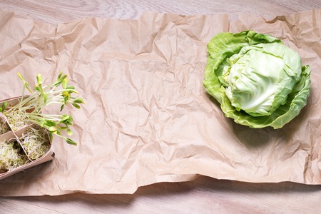 Mixed organic micro greens and cabbage on craft paper. Fresh sunflower and heap of alfalfa micro green sprouts. Healthy food and diet concept. Cut microgreens, top view with copy space.の写真素材