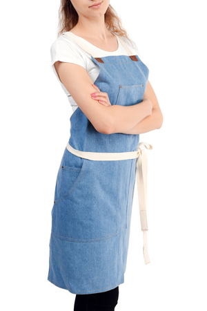 Young redhaired woman chef or waiter posing, wearing apron and t-shirt isolated on white background. Barista cafe coffee uniform.の写真素材