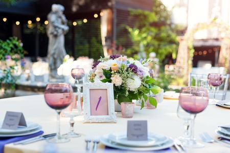Flower table decorations for holidays and wedding dinner. Table set for holiday, event, party or...