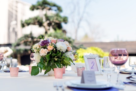 Flower table decorations for holidays and wedding dinner. Table set for holiday, event, party or...