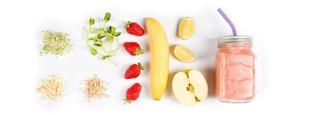 Detox cleanse drink, fruits and berries smoothie ingredients. Natural, organic healthy juice for weight loss diet or fasting day. Mason jar of dietary drink with strawberries, microgreens and bananaの写真素材