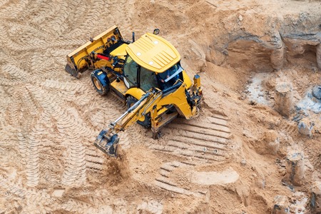 Construction of concrete foundation of new building. Construction machinery, excavator, top viewの写真素材