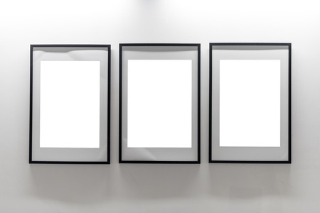 Mock up. Blank picture frames on white wall. Gallery wall with empty frames indoorの写真素材