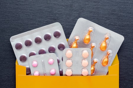 Pharmaceutical medicine and supplement with capsules and tablets in package. Medical treatment that...