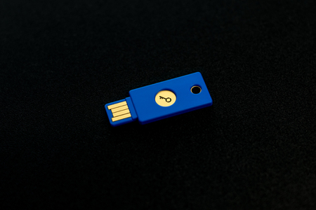 Security system concept. Key-shaped USB drive on dark background. Technology and data security theme.の写真素材