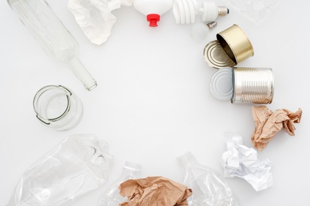 Recyclable waste, resources. Clean glass, paper, plastic and metal on white background. Copyspace for text. Recycling, reuse, garbage disposal, resources environment and ecology conceptの写真素材
