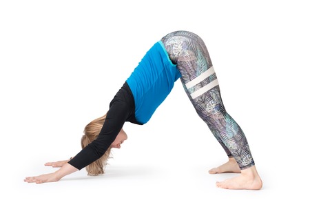 Young woman doing yoga practice isolated on white background. Concept of healthy life and natural balance between body and mental development. Attractive blonde woman stretching.の写真素材