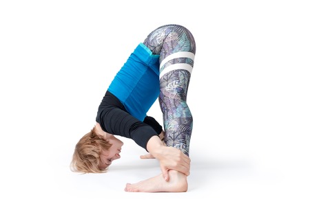 Young woman doing yoga practice isolated on white background. Concept of healthy life and natural...